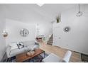 Bright living room with vaulted ceiling, white walls, modern decor, and hardwood flooring at 7072 Palisade Dr, Highlands Ranch, CO 80130