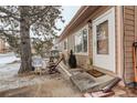 Quaint front entrance with cozy outdoor seating, a charming walkway, and a welcoming, tree-lined neighborhood at 841 Crisman Dr # 9, Longmont, CO 80501