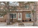 Inviting townhouse entrance with a well-maintained walkway, cozy seating, and a serene, tree-lined neighborhood at 841 Crisman Dr # 9, Longmont, CO 80501