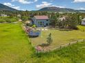 Spacious backyard featuring a trampoline and wooden play structure at 133 Wheat Ridge St, Palmer Lake, CO 80133