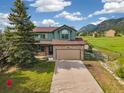 Inviting two-story home featuring a stone facade and two-car garage at 133 Wheat Ridge St, Palmer Lake, CO 80133