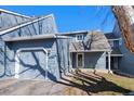 Charming townhome with an attached two-car garage, inviting covered porch and well-manicured lawn at 10634 Park Mtn, Littleton, CO 80127