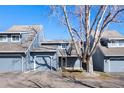 Charming townhome featuring a two-car garage, inviting front porch and beautifully maintained landscaping at 10634 Park Mtn, Littleton, CO 80127