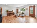Bright living room featuring hardwood floors, a large window, comfortable seating, and a stylish decor at 3380 S Ogden St, Englewood, CO 80113