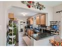 Well-equipped kitchen with granite countertops, wooden cabinets, and stainless steel appliances at 1309 Jamaica St, Aurora, CO 80010