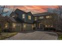 Two-story home with three-car garage showing a welcoming exterior at twilight at 22386 E Arbor Pl, Aurora, CO 80016