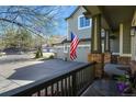 View from the porch of a home with a three-car garage and American flag at 22386 E Arbor Pl, Aurora, CO 80016