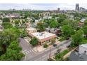 Aerial view showcasing the building's roof, surrounding trees, and urban skyline in the distance at 2862 Champa St, Denver, CO 80205