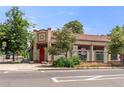 Charming building featuring brick accents, a red door, and classic architectural details at 2862 Champa St, Denver, CO 80205