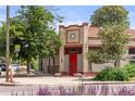 Charming building featuring brick accents, a red door, and classic architectural details at 2862 Champa St, Denver, CO 80205