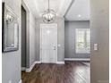 Inviting foyer with chandelier lighting, hardwood floors, and neutral paint at 22656 E Glidden Dr, Aurora, CO 80016