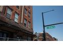 Brick building with stadium lofts entrance and street sign with clear blue sky at 2261 Blake St # 5H, Denver, CO 80205