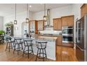 Spacious kitchen with granite countertops, stainless steel appliances, and a breakfast bar at 18926 W 94Th Ave, Arvada, CO 80007