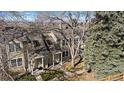 Aerial view of the townhomes featuring well-manicured lawns and mature trees at 1818 S Quebec Way # B15-5, Denver, CO 80231