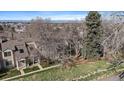 An aerial perspective highlighting the property's layout and landscape within a lush, green setting at 1818 S Quebec Way # B15-5, Denver, CO 80231
