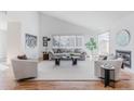 Bright, modern living room with high ceilings, large windows, hardwood floors, and a cozy fireplace at 1835 Columbine Ave, Boulder, CO 80302