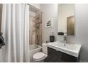 Cozy bathroom featuring a shower-tub combo with decorative tile, a modern vanity, and a neutral color palette at 2103 W 32Nd Ave # 10, Denver, CO 80211