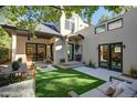 Outdoor space showcasing a patio with stylish seating, a green lawn area, and elegant access to the home's interior at 2434 Mapleton Ave, Boulder, CO 80304