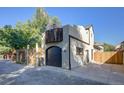 Contemporary exterior featuring a modern design with wood accents, a garage, and a private fence for added curb appeal at 2434 Mapleton Ave, Boulder, CO 80304