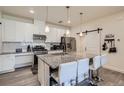 Contemporary kitchen featuring white cabinets, granite countertops, stainless steel appliances and kitchen island at 16841 Askins Loop # 105, Parker, CO 80134