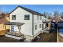 Two-story modern home with gray siding, showcasing a deck and yard at 3880 Sheridan Blvd, Denver, CO 80212