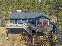 Beautiful home featuring a spacious deck with outdoor seating and views of surrounding trees at 30858 Niakwa Rd, Evergreen, CO 80439
