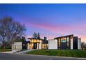 Stylish home featuring stone accents, flat roofline, modern design and professional landscaping at 2960 E Floyd Dr, Denver, CO 80210