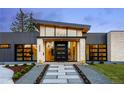 Contemporary home entrance with a stone walkway, modern door, and manicured landscaping at 2960 E Floyd Dr, Denver, CO 80210