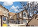 Two-story townhome featuring neutral siding with brown trim, a walkway, and stairs to the front door at 1816 S Pagosa Way # 5, Aurora, CO 80017