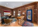 Cozy living room showcasing exposed brick walls, hardwood floors, natural light, and contemporary decor at 3313 Curtis St, Denver, CO 80205