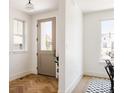 Inviting entryway with herringbone wood floors, natural light, and a view of the neighborhood at 4131 Quivas St, Denver, CO 80211