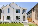 Charming white two-story home with a well-manicured lawn and attractive curb appeal at 4131 Quivas St, Denver, CO 80211