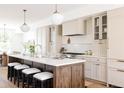Spacious kitchen featuring an island with stools, stylish pendant lighting and modern appliances for cooking at 4131 Quivas St, Denver, CO 80211