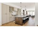 Bright open kitchen featuring a large island with seating, modern appliances, and hardwood flooring, perfect for cooking at 4131 Quivas St, Denver, CO 80211