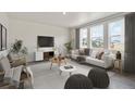 Bright living room with ample natural light, neutral furnishings, and stylish decor offering a welcoming space at 18399 Field Mint Pt, Parker, CO 80134