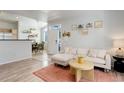 Inviting living room featuring a comfortable couch and seamless access to the kitchen and dining area at 8500 E Jefferson Ave # 3H, Denver, CO 80237