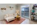 Bright living room with a sectional sofa and sliding glass doors leading to an outdoor balcony at 8500 E Jefferson Ave # 3H, Denver, CO 80237
