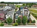 Aerial view of a neighborhood, showcasing the home's location near a pond and green spaces at 1376 Snowberry Ln, Louisville, CO 80027
