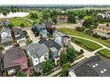 A high-angle aerial shot showcases the home's position near a pond with walking trails at 1376 Snowberry Ln, Louisville, CO 80027