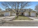 Charming townhome with attached garages, well-maintained landscaping, and mature tree at 7822 S Kittredge Cir, Englewood, CO 80112