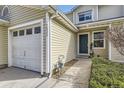 Well-maintained home featuring an attached garage, neutral siding, and a welcoming entrance at 7822 S Kittredge Cir, Englewood, CO 80112