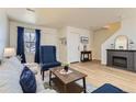 Cozy living room with hardwood floors, fireplace, and comfortable seating area at 7822 S Kittredge Cir, Englewood, CO 80112