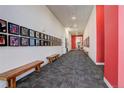 Bright hallway adorned with artwork and accented by stylish benches and decor at 3500 S Corona St # 205, Englewood, CO 80113