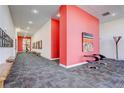 Inviting hallway with contemporary art, seating, and vibrant accent wall at 3500 S Corona St # 205, Englewood, CO 80113