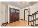 Beautiful foyer with hardwood floors, stunning front door, chandelier and staircase at 8075 S Harrison Way, Centennial, CO 80122