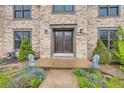 Stately entrance to a brick home featuring a dark wood double door and stone lion accents at 8075 S Harrison Way, Centennial, CO 80122
