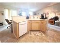 Open kitchen view featuring a breakfast bar, modern appliances, and tile flooring at 5860 W 115Th Ave, Westminster, CO 80020