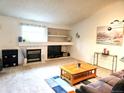 Bright living room with a cozy fireplace, built-in shelving, and comfortable seating at 5860 W 115Th Ave, Westminster, CO 80020