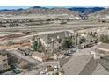 Scenic condo community with garages, greenery, and mountain views at 9568 W San Juan Cir # 203, Littleton, CO 80128
