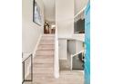 Inviting home entryway showcasing a staircase with wood steps and a modern railing design at 2027 S Welch Cir, Lakewood, CO 80228
